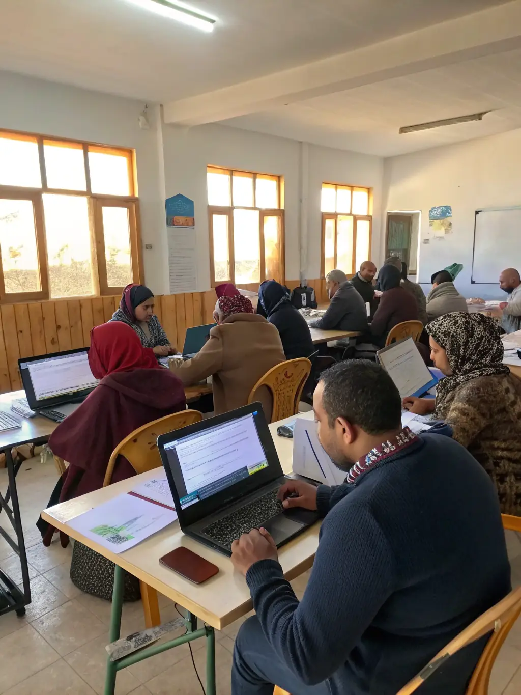 A professional shot of a workshop session at a tech conference in Birmingham, with participants actively engaged in hands-on learning.