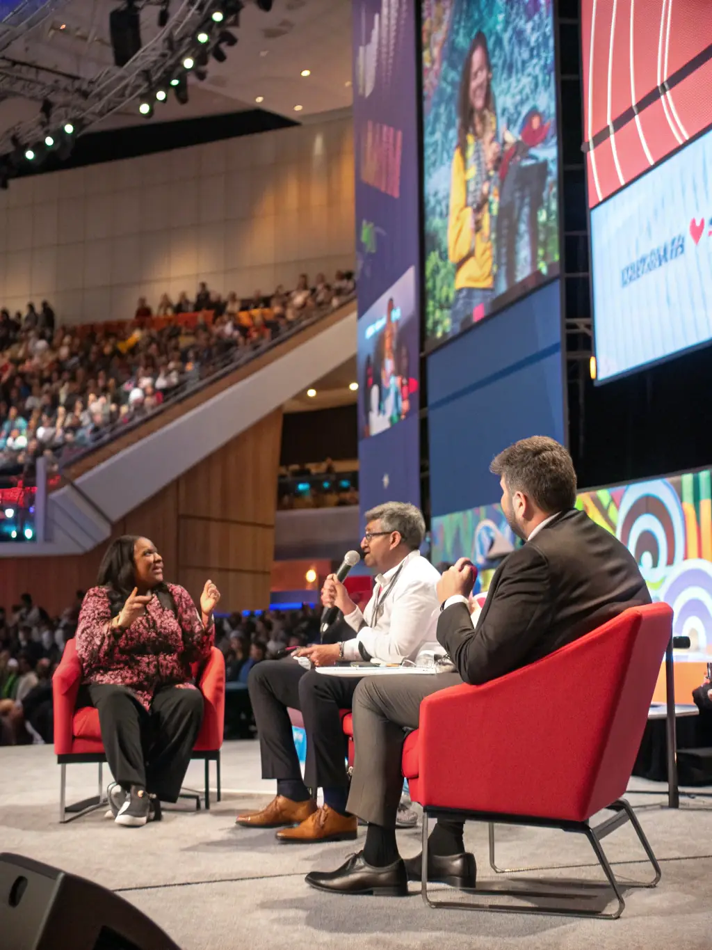 A dynamic image of a panel discussion at a tech conference in Manchester, featuring diverse speakers and engaged audience members.
